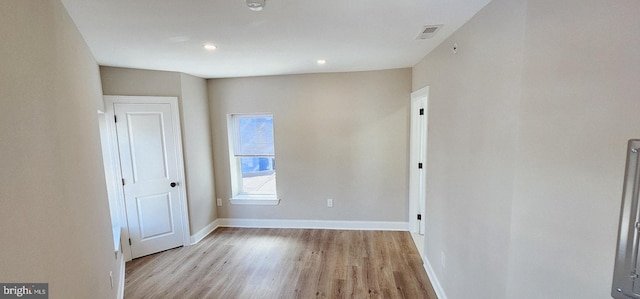 spare room with light hardwood / wood-style flooring