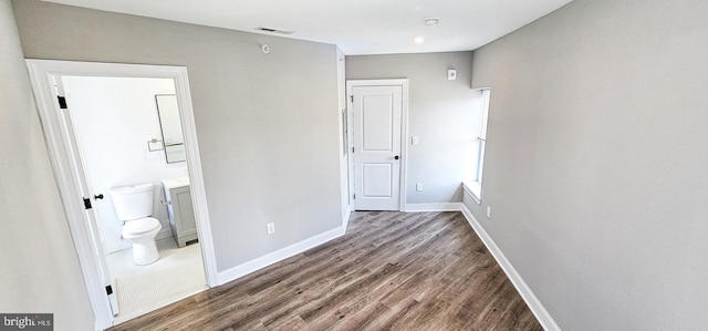 interior space with hardwood / wood-style flooring and connected bathroom