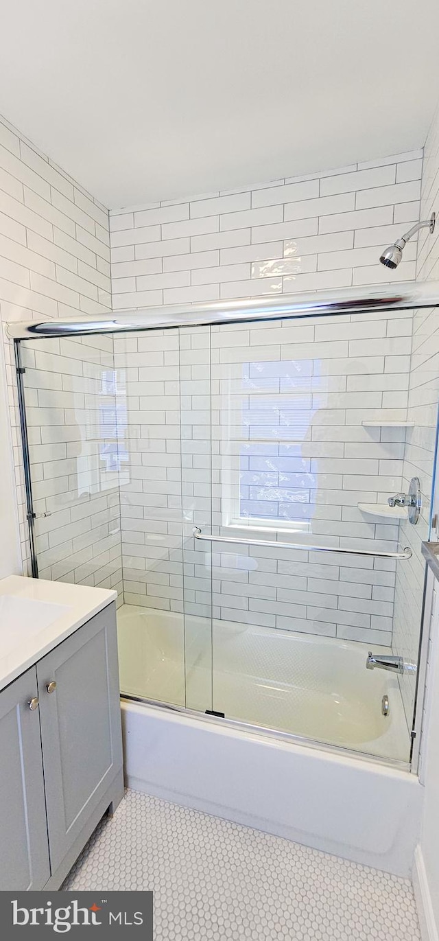 bathroom featuring vanity and combined bath / shower with glass door