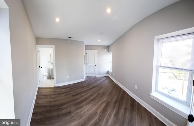 empty room with dark hardwood / wood-style floors