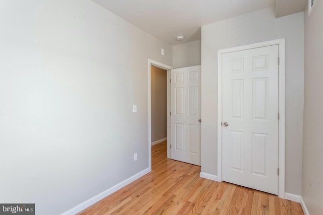 unfurnished bedroom featuring light wood-type flooring