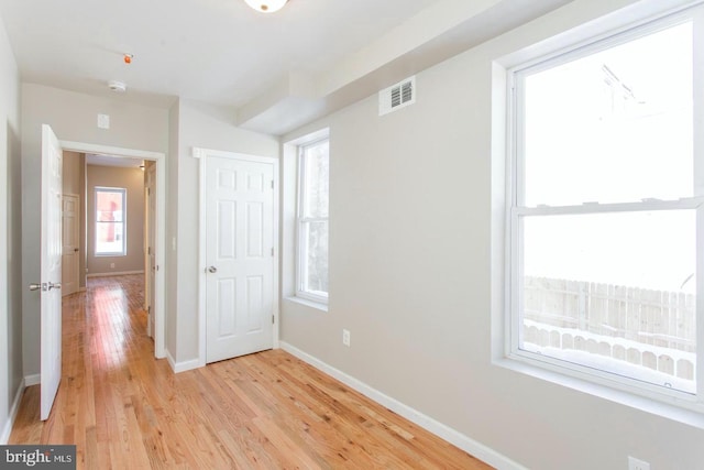 unfurnished bedroom with light wood-type flooring