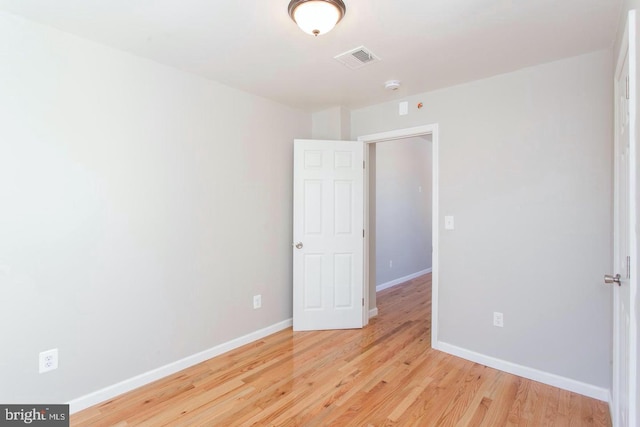 empty room with light hardwood / wood-style flooring