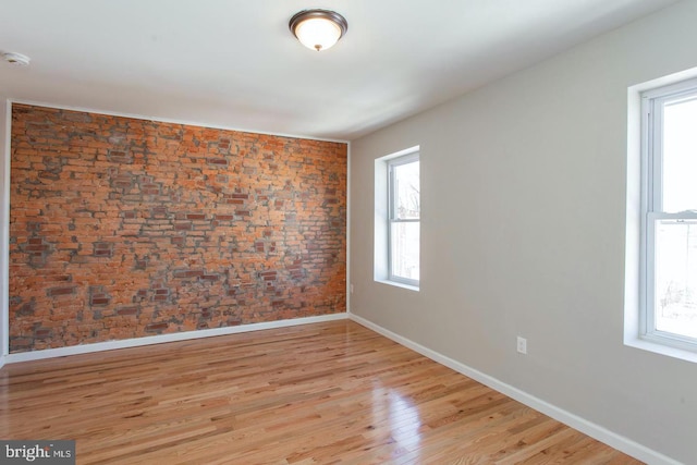 unfurnished room featuring light wood-type flooring and plenty of natural light