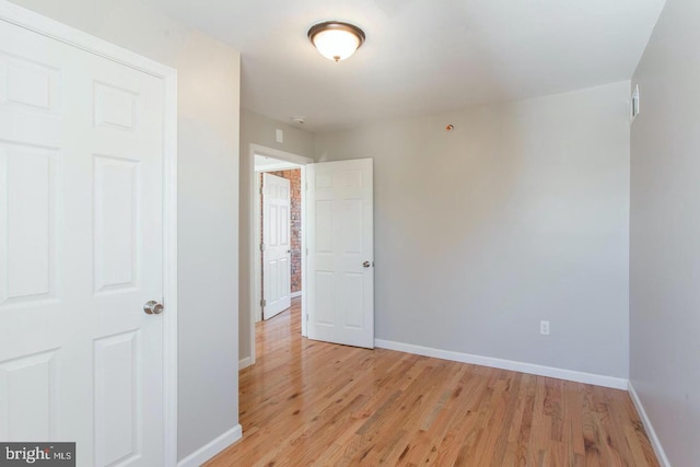 empty room with light hardwood / wood-style floors