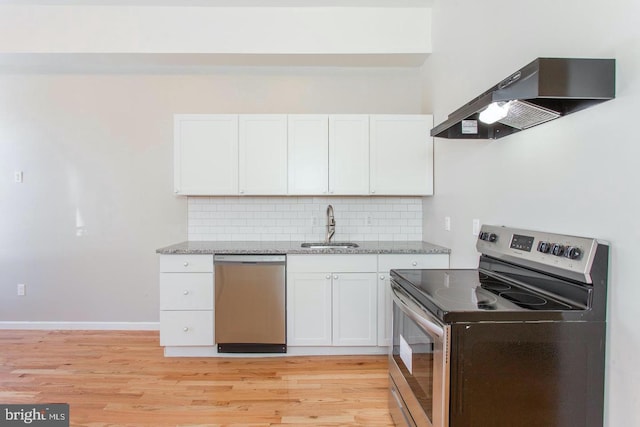 kitchen with stainless steel appliances, white cabinets, sink, ventilation hood, and light wood-type flooring