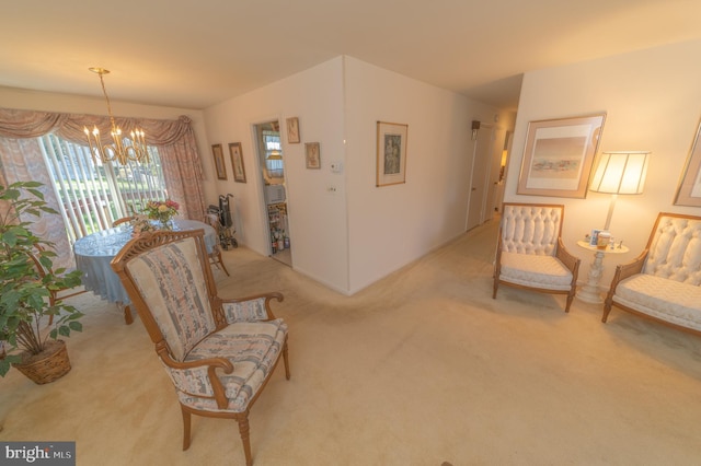 sitting room featuring light carpet and a notable chandelier