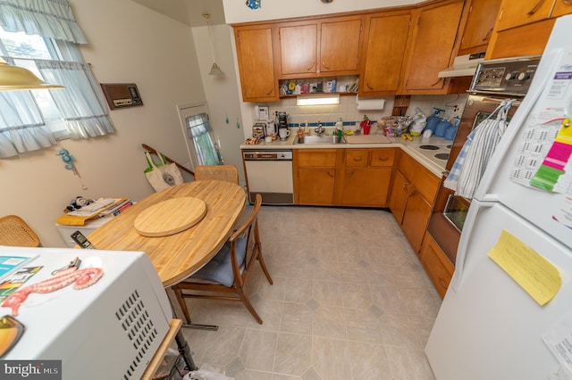 kitchen with light tile patterned floors, white appliances, backsplash, and sink