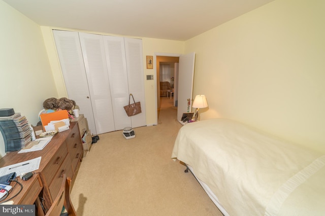 carpeted bedroom featuring a closet