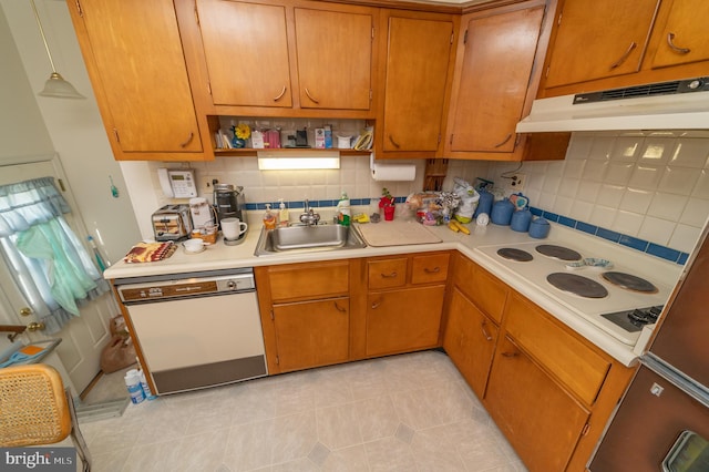 kitchen with backsplash, white appliances, sink, and decorative light fixtures