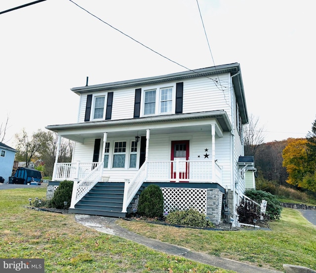 view of front of house with a porch and a front lawn