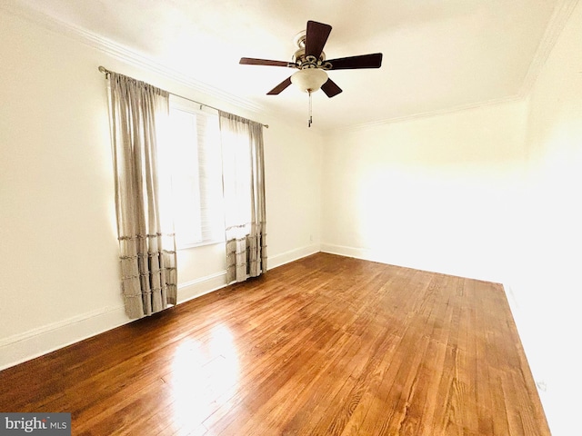 spare room with wood-type flooring, ceiling fan, and crown molding