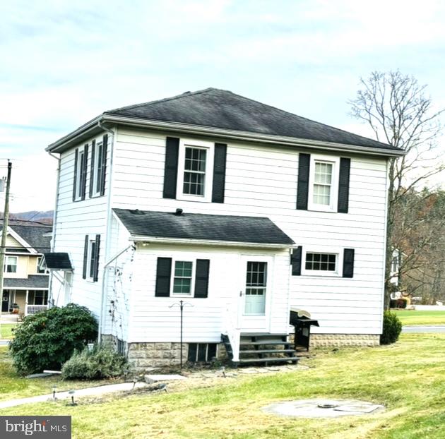 rear view of property with a lawn