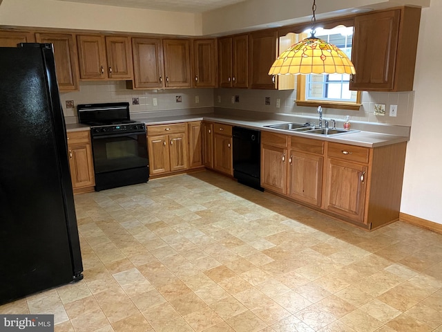 kitchen featuring decorative backsplash, black appliances, sink, and decorative light fixtures