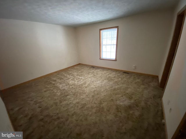 spare room featuring carpet floors