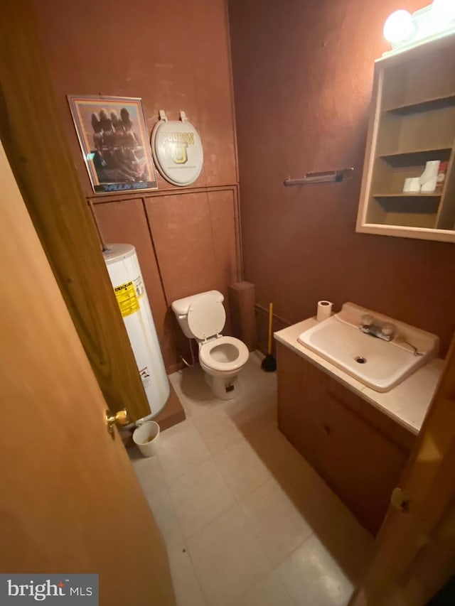 bathroom with water heater, vanity, and toilet