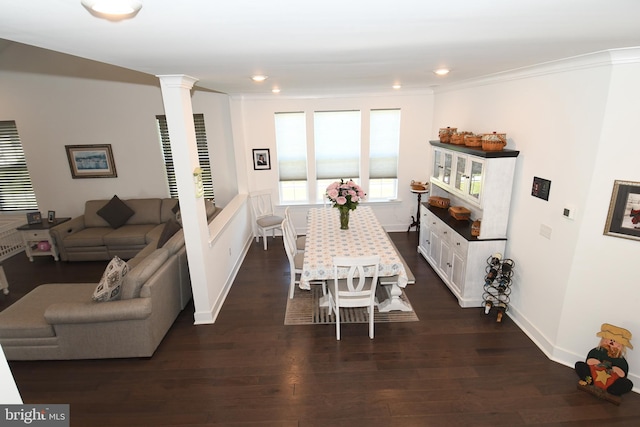 dining area featuring dark hardwood / wood-style floors, ornamental molding, and decorative columns