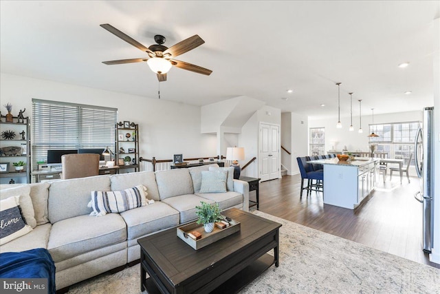 living room with dark hardwood / wood-style floors and ceiling fan