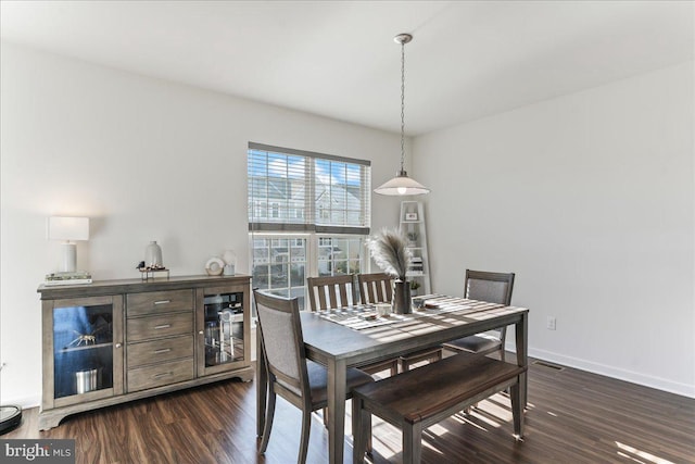 dining area with dark hardwood / wood-style floors