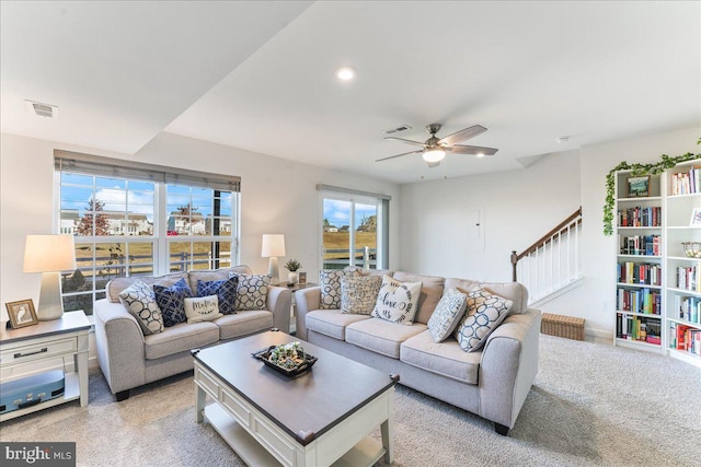 carpeted living room featuring ceiling fan