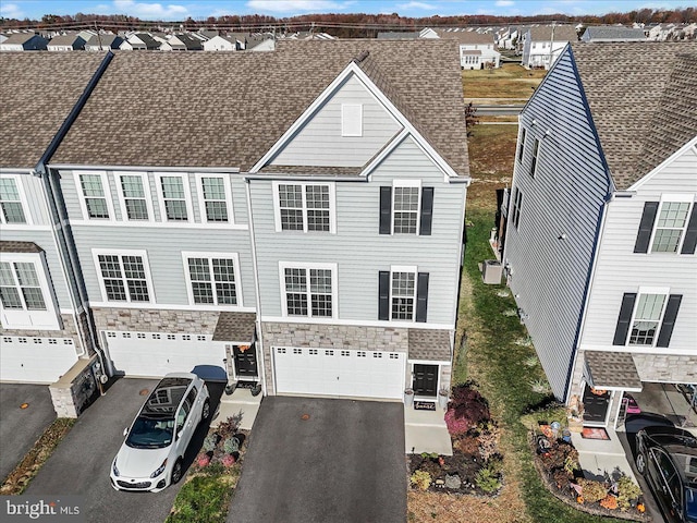 multi unit property featuring a garage