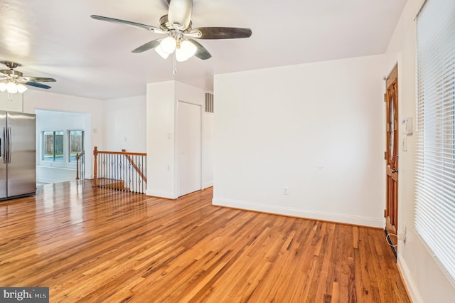 unfurnished room featuring ceiling fan and light hardwood / wood-style flooring