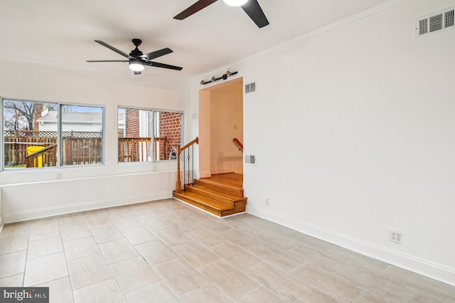 tiled spare room with ceiling fan and crown molding