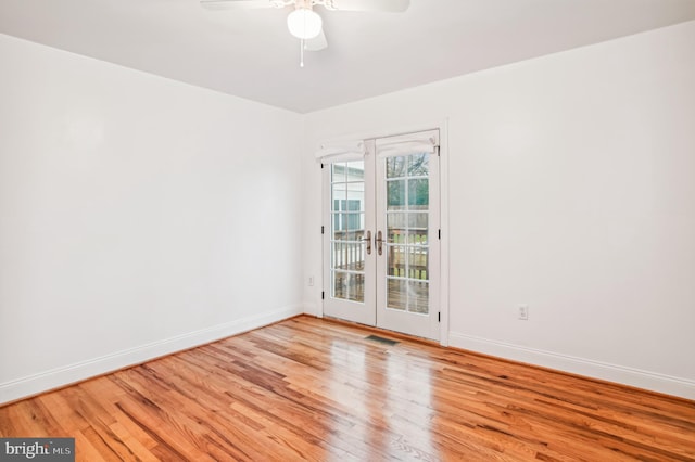 empty room featuring french doors, light hardwood / wood-style floors, and ceiling fan