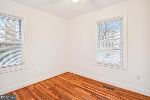 spare room with ceiling fan and hardwood / wood-style floors