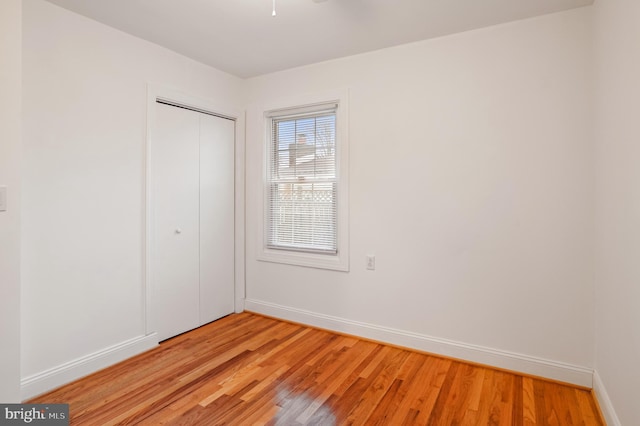 unfurnished bedroom with a closet and light hardwood / wood-style flooring