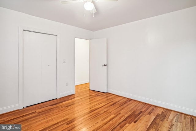 unfurnished bedroom featuring a closet, ceiling fan, and light hardwood / wood-style flooring