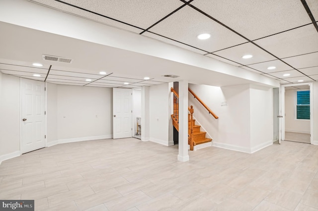 basement featuring a drop ceiling