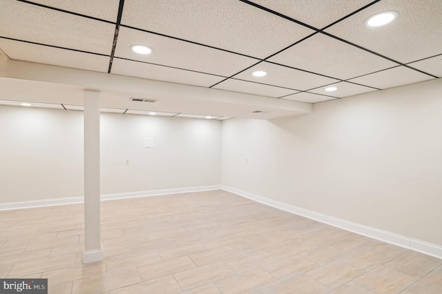 basement with a paneled ceiling