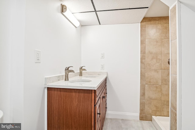 bathroom with vanity and a tile shower