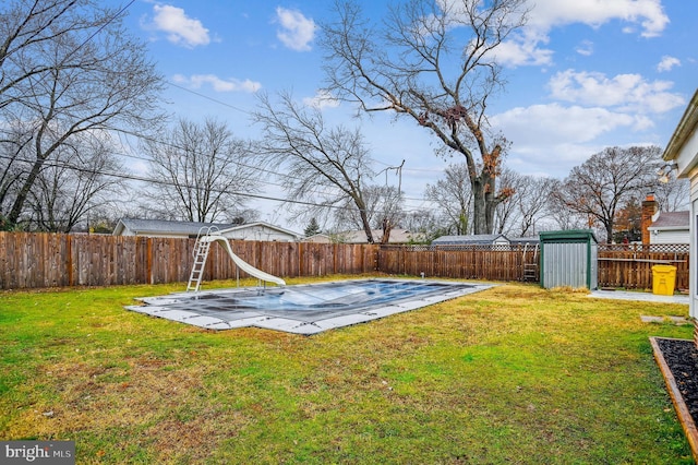 view of yard featuring a storage shed and a patio area