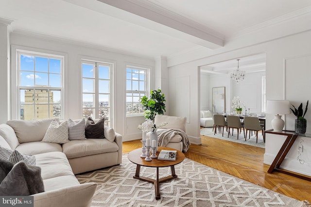 living room with beam ceiling, parquet flooring, a notable chandelier, and ornamental molding