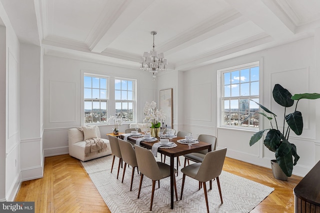 dining room with a notable chandelier, beamed ceiling, light parquet floors, and ornamental molding