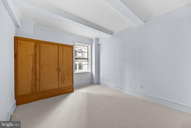 unfurnished bedroom with light colored carpet, crown molding, and beam ceiling