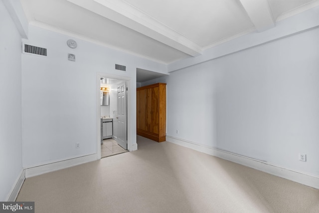 unfurnished room featuring beam ceiling