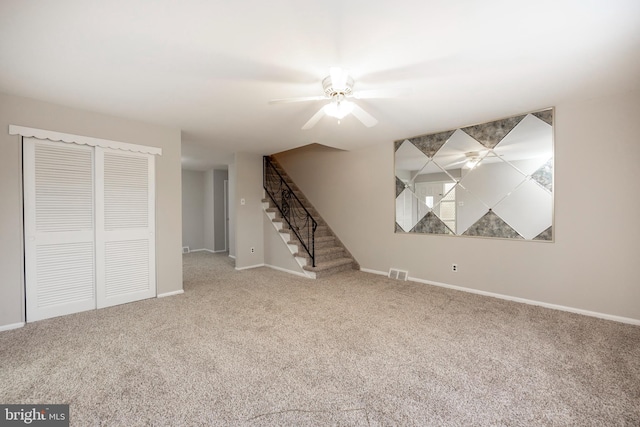 basement featuring carpet floors and ceiling fan