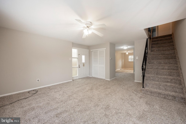 unfurnished living room featuring ceiling fan and light carpet