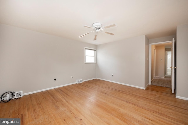 spare room with ceiling fan and light wood-type flooring