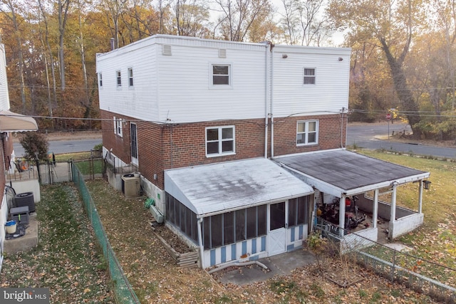 rear view of property with a sunroom