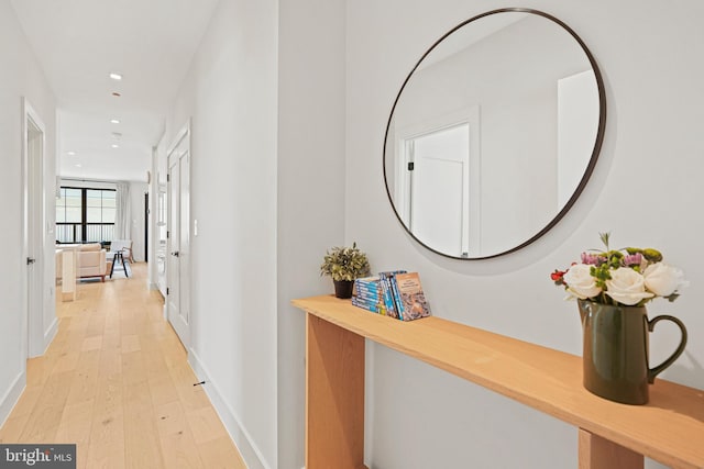 corridor with light hardwood / wood-style flooring