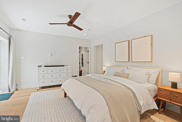 bedroom with light hardwood / wood-style floors and ceiling fan