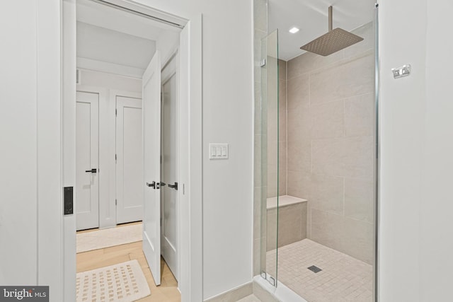 bathroom featuring a shower with door