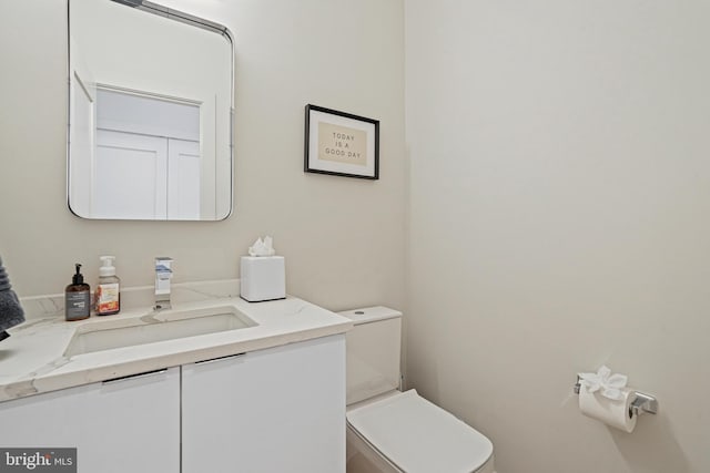 bathroom with toilet and vanity