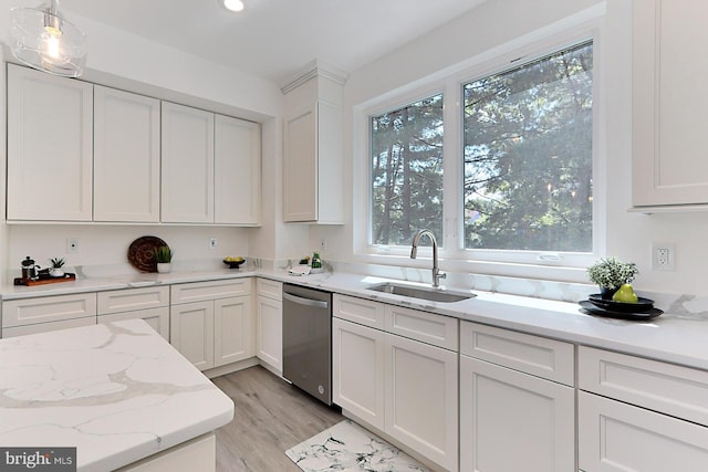 kitchen with white cabinetry, dishwasher, sink, plenty of natural light, and decorative light fixtures