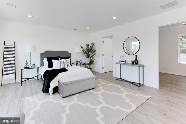 bedroom with light wood-type flooring and multiple windows