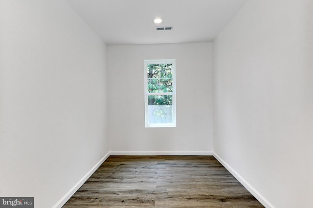 spare room featuring wood-type flooring